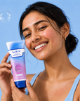 Woman holding a Calme product against a blue background